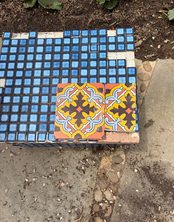 Setting Talavera tiles against the old blue mosaic