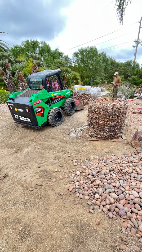 Moving river rock into place
