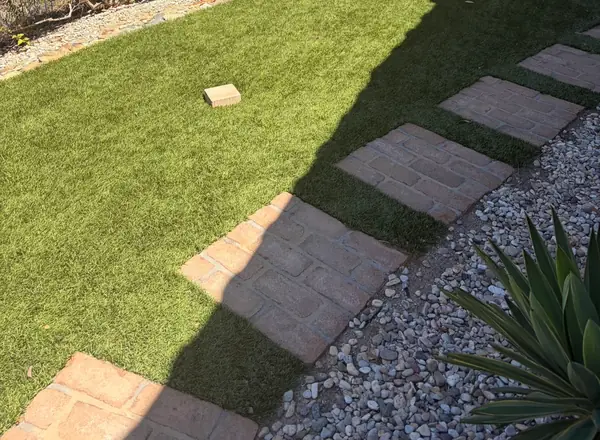 Stepping pavers across artificial turf